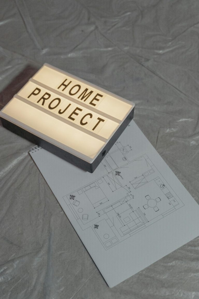 Illuminated home project sign with architectural floor plan on gray background, perfect for construction themes.